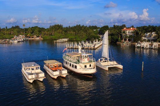 A group of boats are floating on top of a body of water.