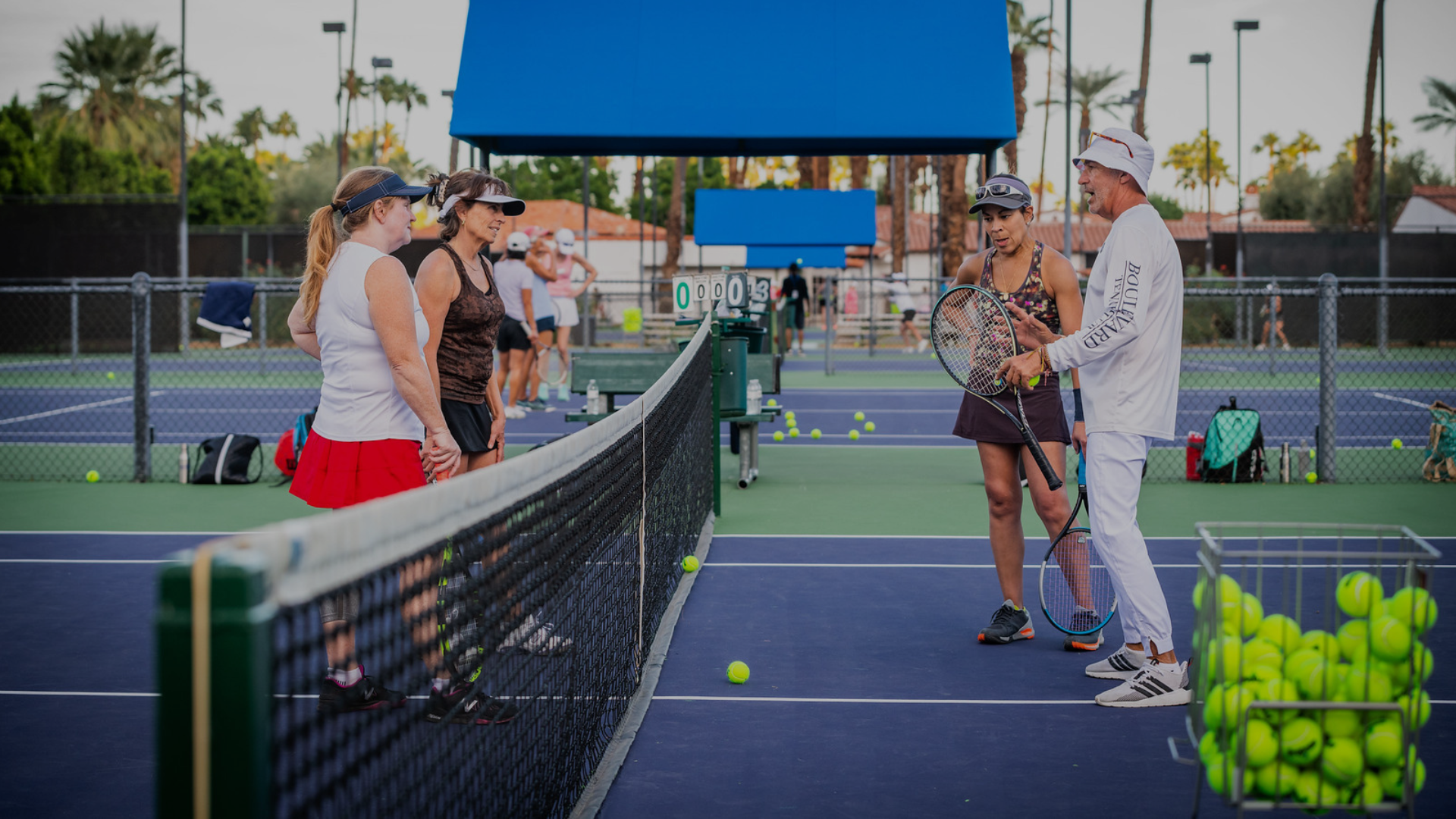 Coach demonstrates doubles net positioning, including holding, faking, poaching, and hovering.