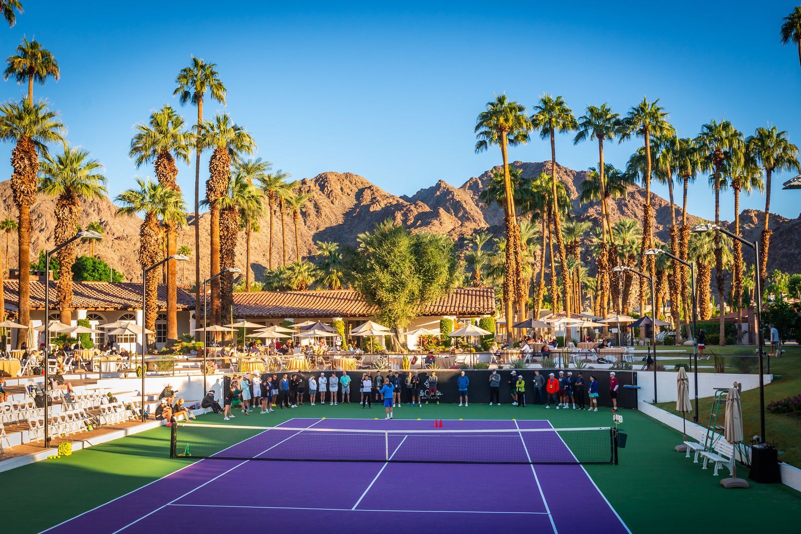 Tennis Congress players on court at La Quinta with the mountains visible in the background.