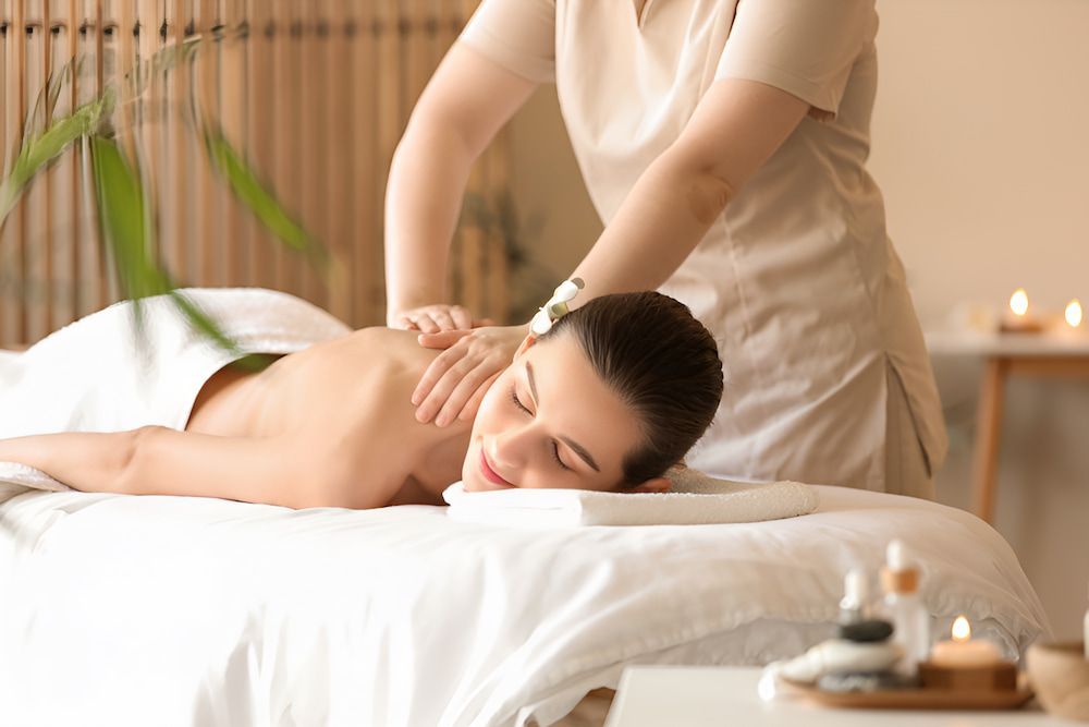 A Woman Is Getting A Massage In A Spa — Sea & Sand Chiropractic In Toukley, NSW