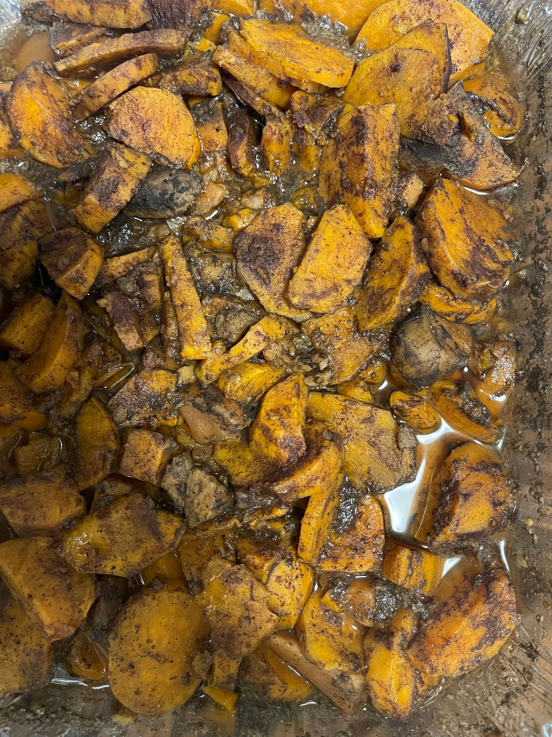 Close-up of a pile of cooked orange and brown mushroom pieces in liquid