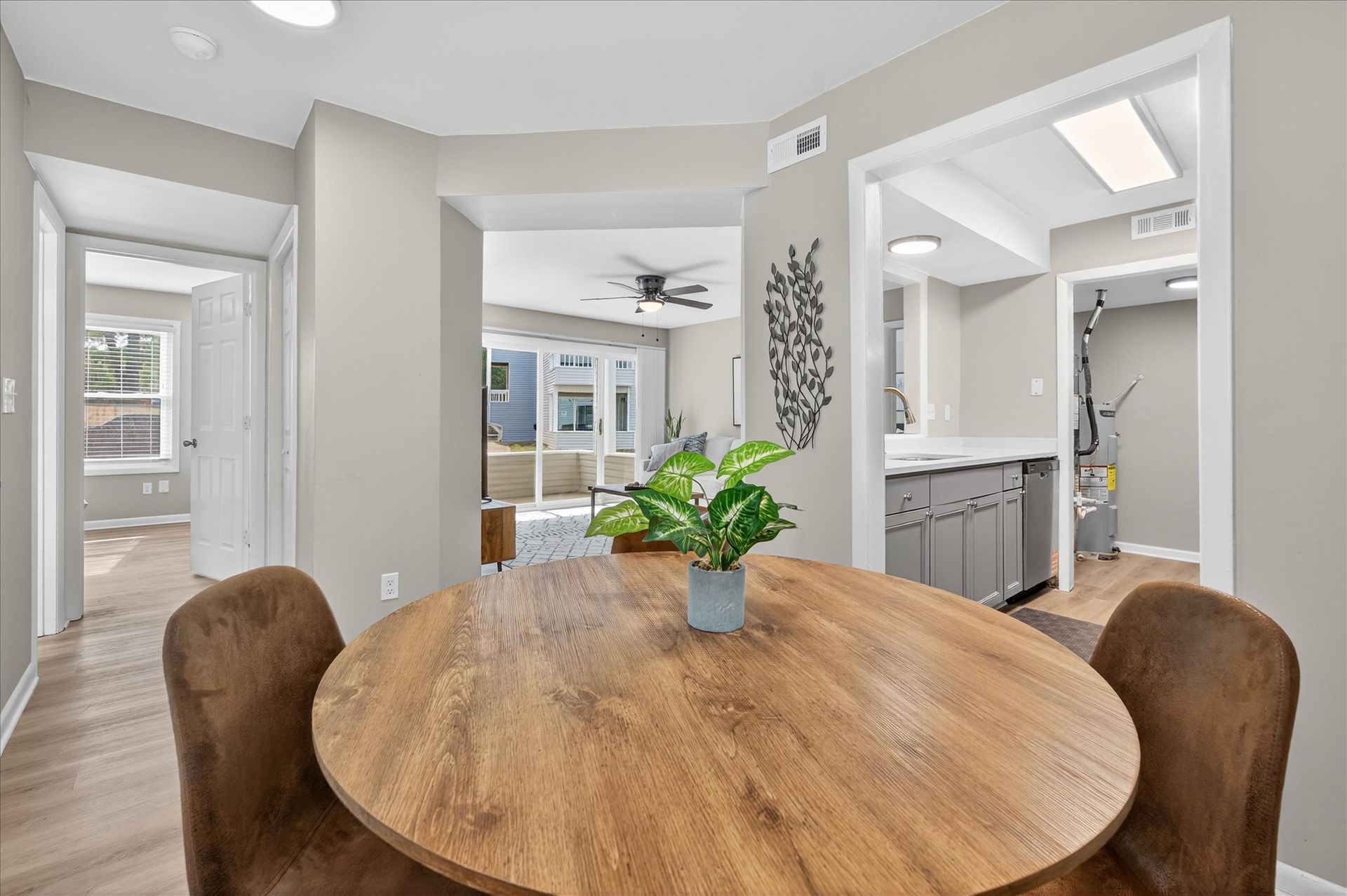 Dining table in bright open-plan home with kitchen and living area in the background