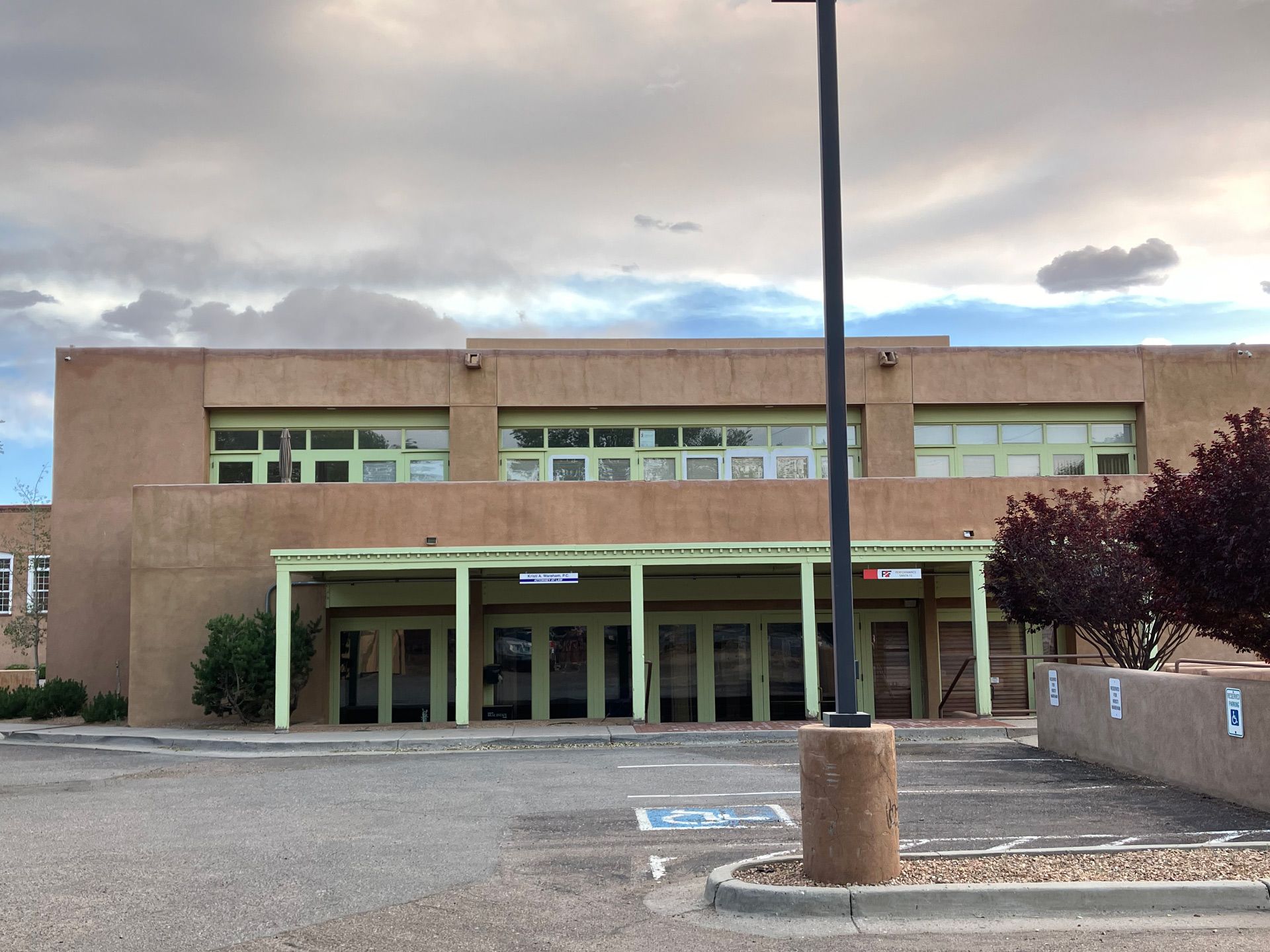A large building with a parking lot in front of it in Santa Fe