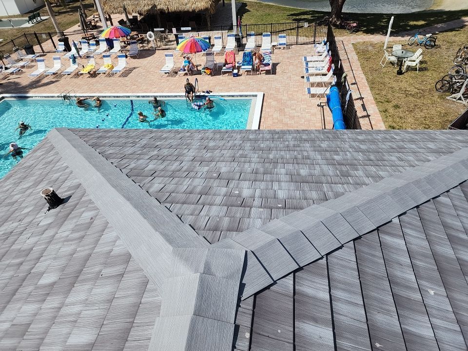 An aerial view of a swimming pool with people swimming in it.