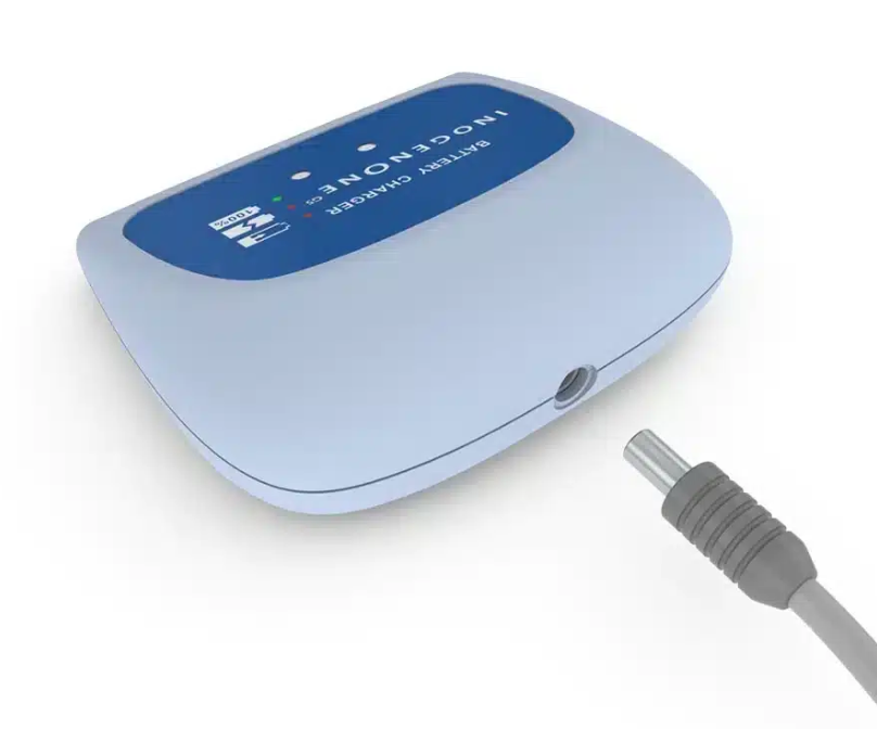 Cargador de baterías INOGENE azul con pantalla digital sobre una base gris claro