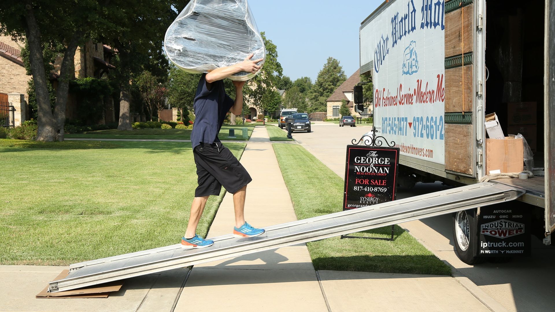 Person Carrying Wrapped Item up Ramp Into Moving Truck — Barnes Transport and Removals in Wardell, NSW 