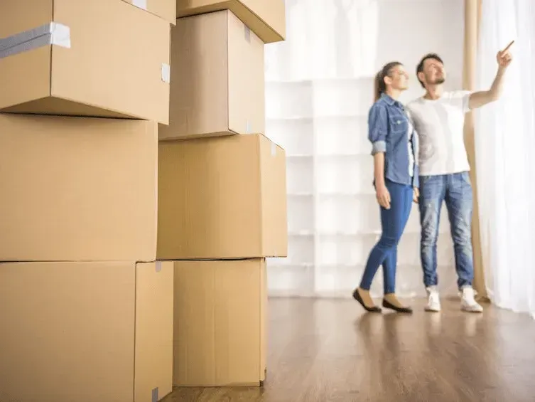 Couple in New Home with Moving Boxes — Barnes Transport and Removals in Wardell, NSW