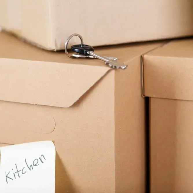 Cardboard Boxes Stacked, with A Key on Top — Barnes Transport and Removals in Wardell, NSW