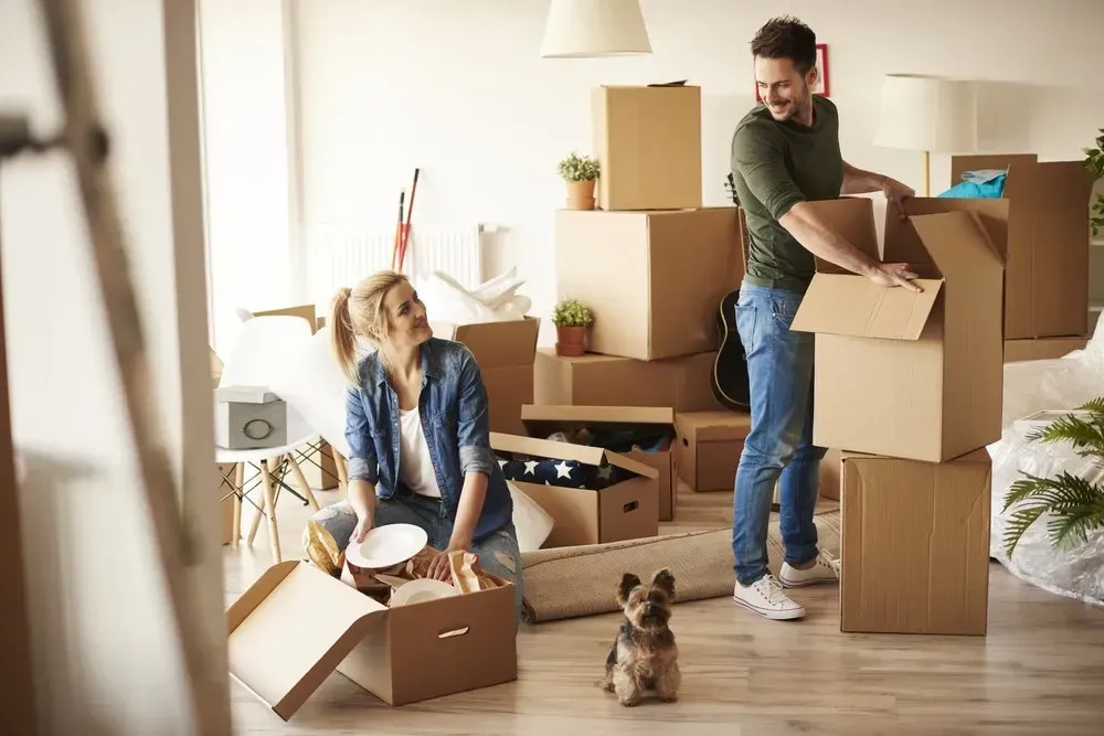 Couple Unpacking Boxes in A New Home — Barnes Transport and Removals in Wardell, NSW
