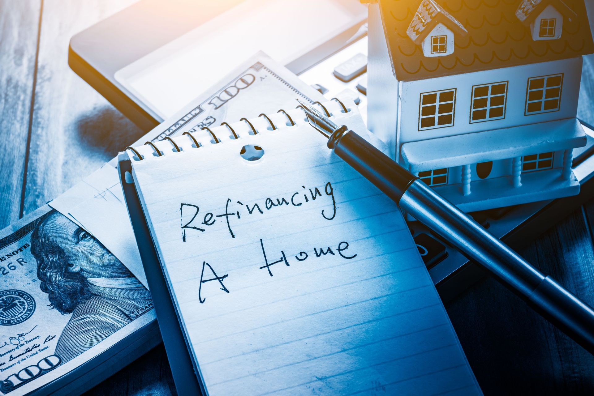refinancing words on notebook us dollars