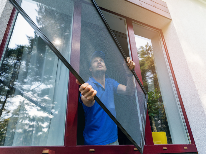 Corona Screen Repair technician doing window screen replacement