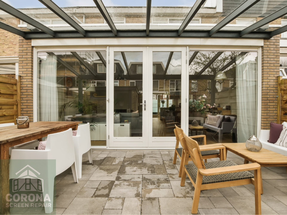 outside patio white framed French door with new retractable screen door installed by Corona Screen Repair