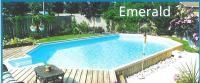A large swimming pool is surrounded by trees and a wooden deck.
