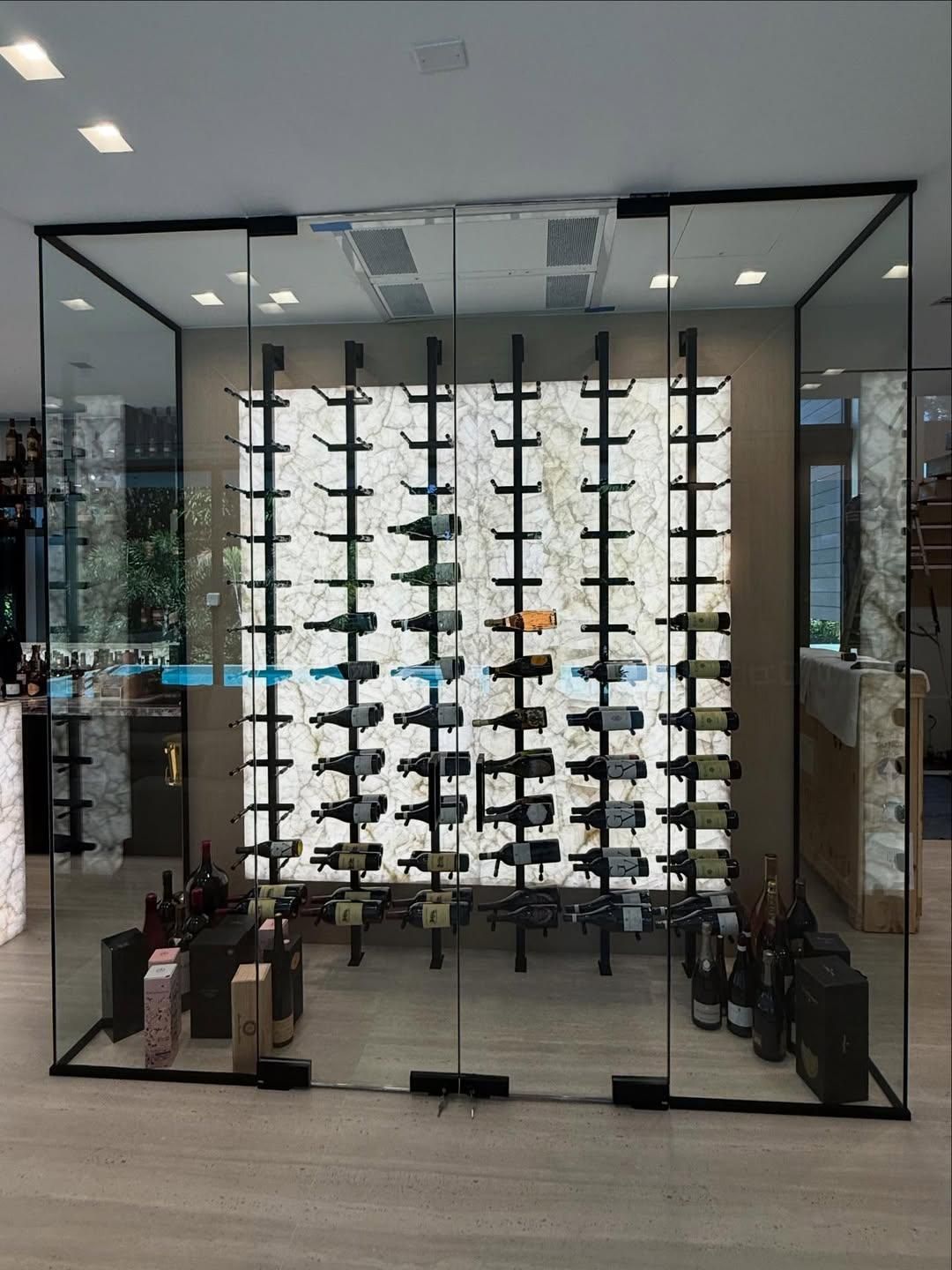 Glass storefront display of eyeglasses on black racks in a modern optical shop