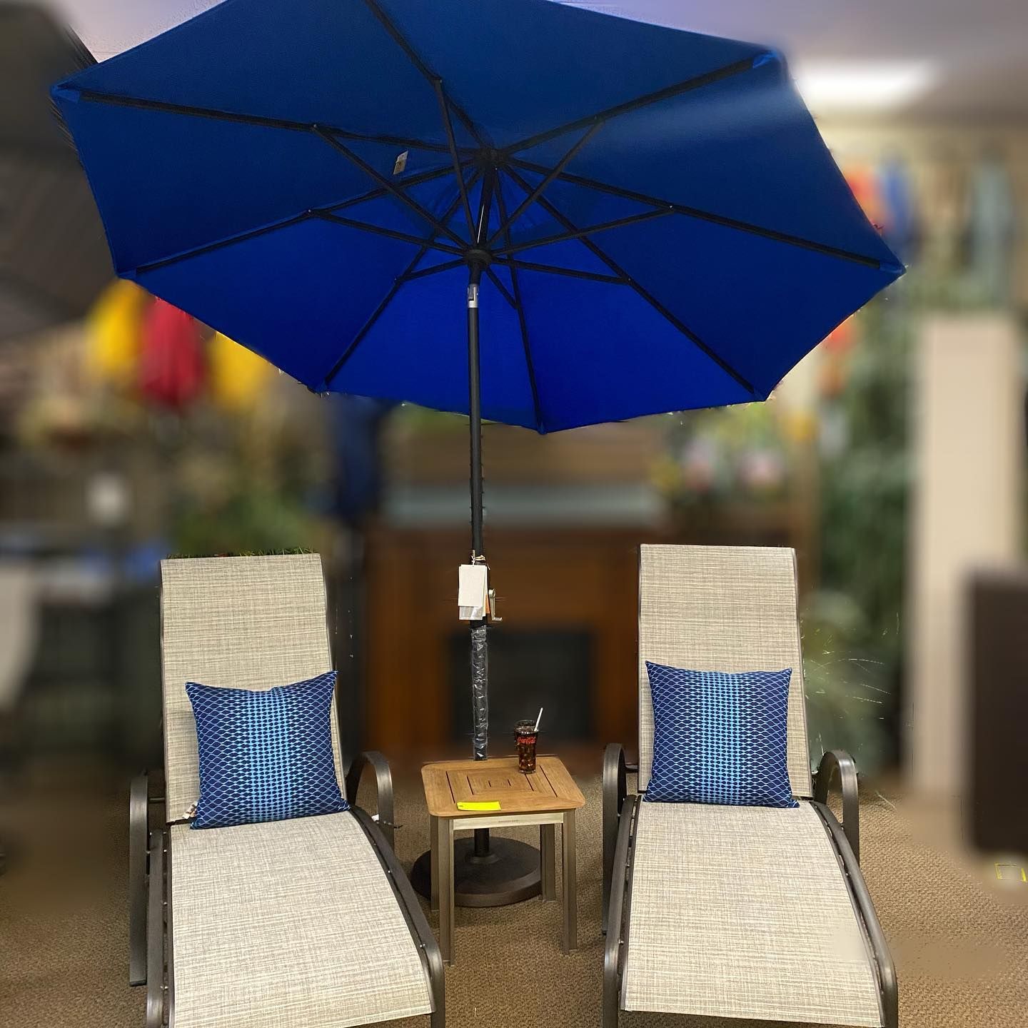 Blue patio umbrella and two chairs