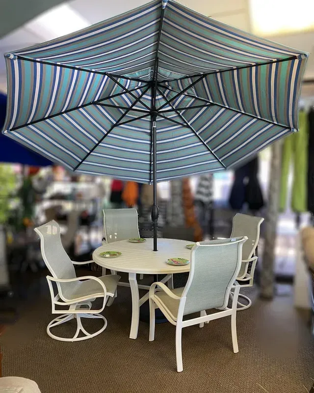 A Table and Chairs Under an Umbrella in A Store.