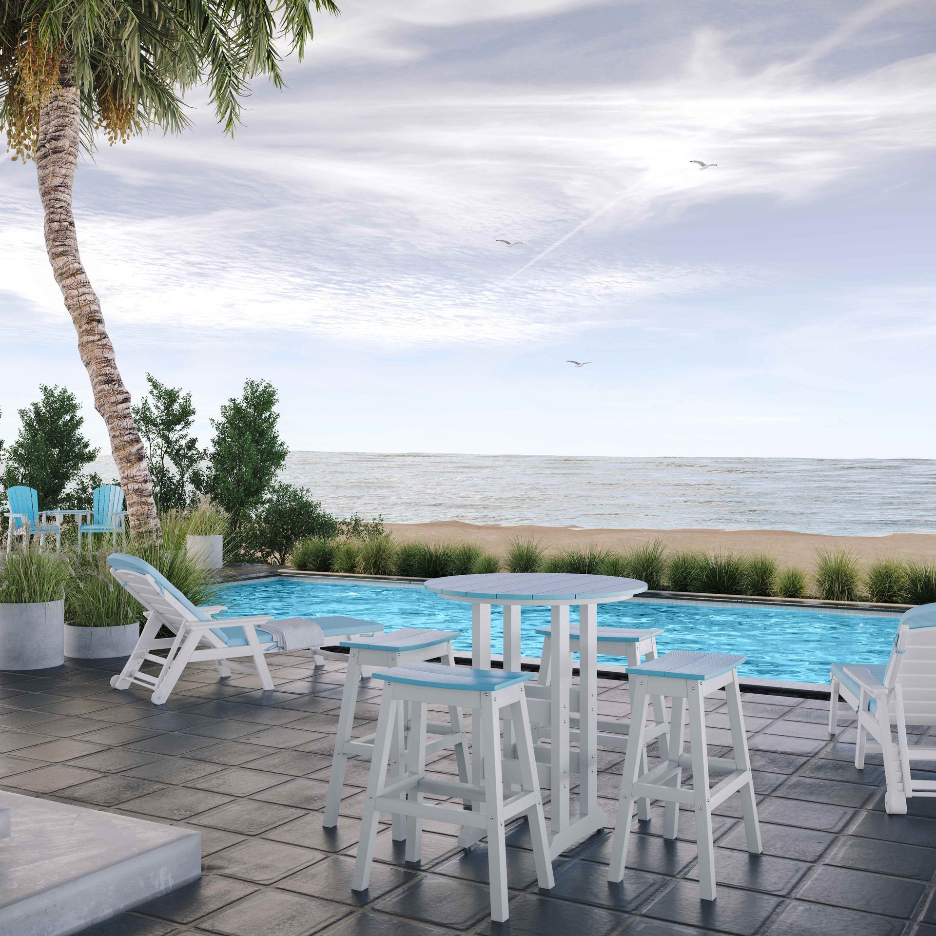 Outdoor patio with pool, ocean view. White bar table and stools, lounge chairs, palm tree.