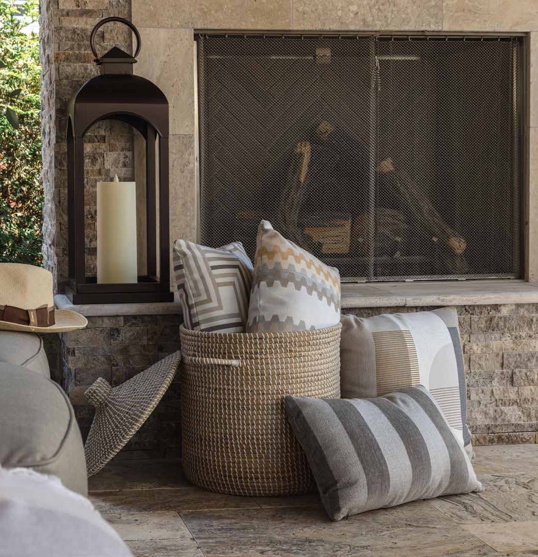 A fireplace with a lantern and pillows in front of it