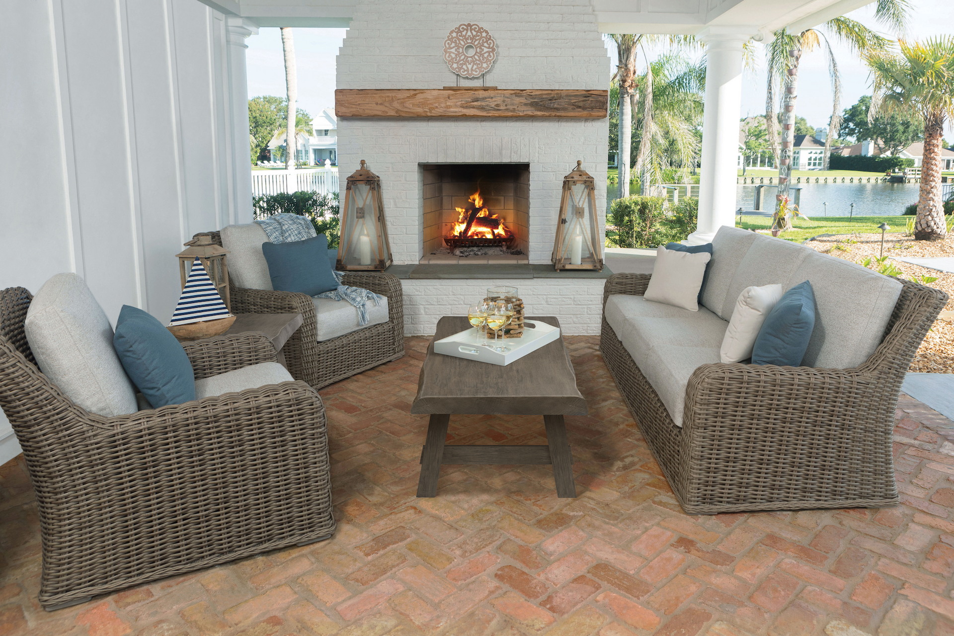 A living room with wicker furniture and a fireplace.