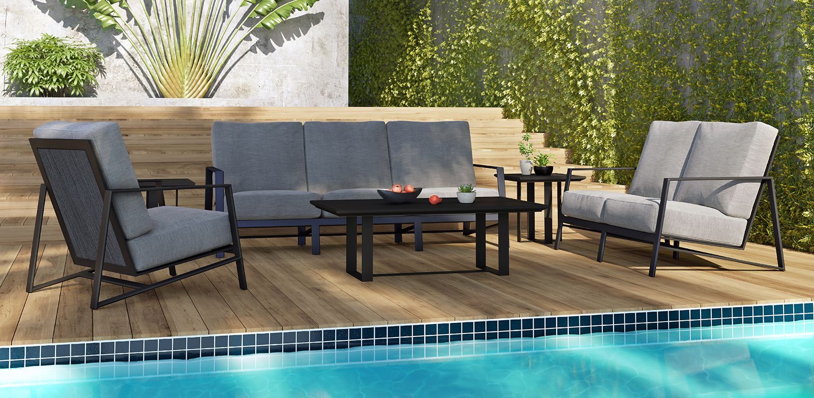 A patio set is sitting next to a swimming pool.