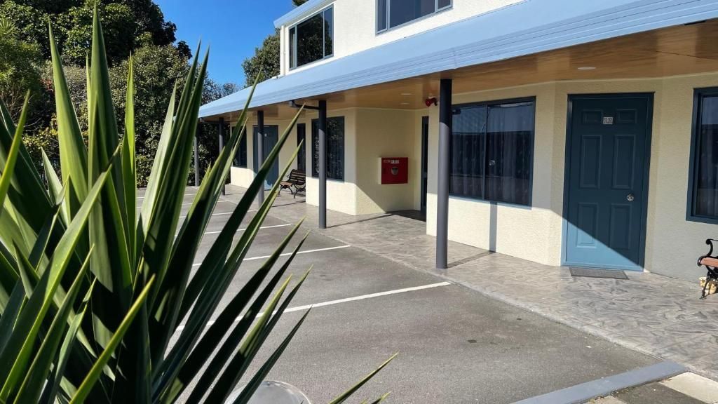 A building with a canopy over it and a plant in front of it.