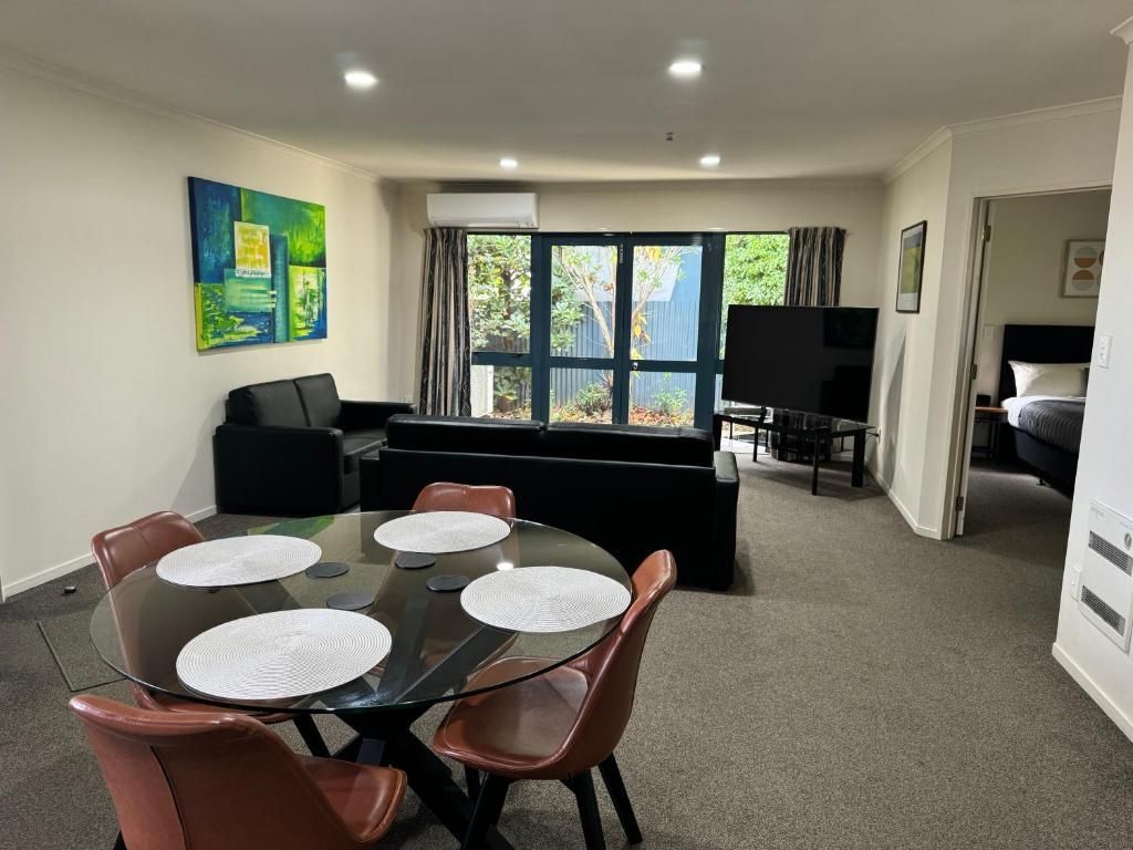 A living room with a table and chairs and a couch.