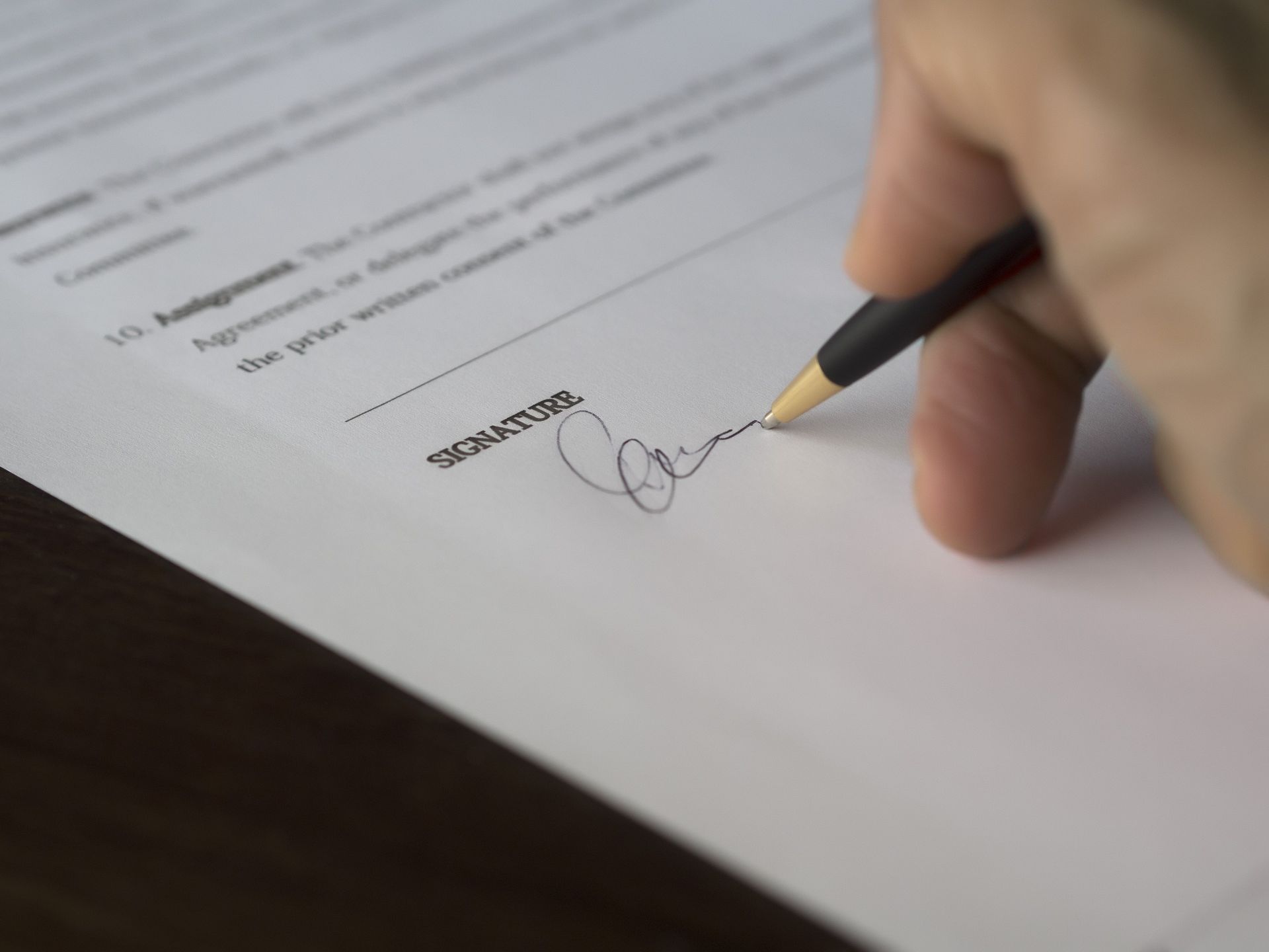 Two business professionals reviewing a letter of intent document at a conference table