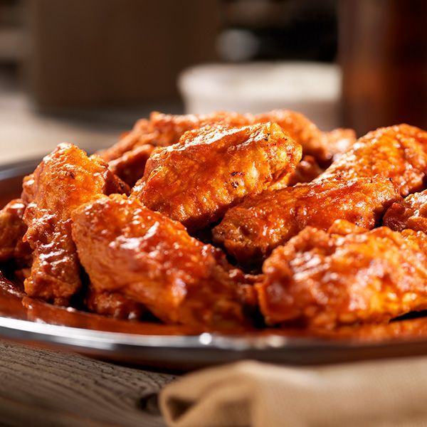a close up of a plate of buffalo wings on a table