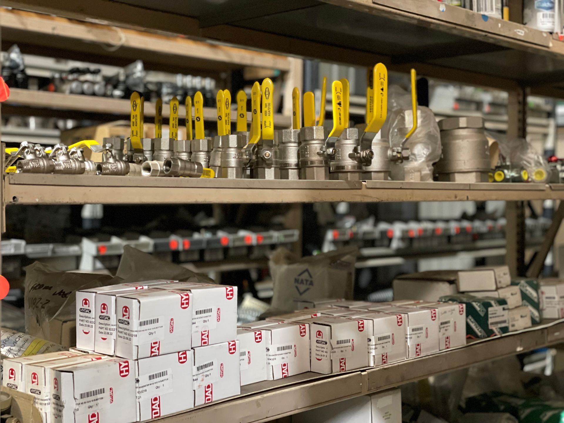 A warehouse filled with shelves filled with lots of different types of valves.