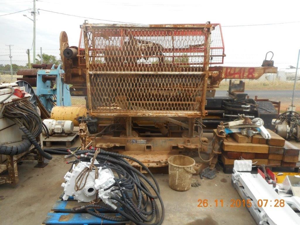 A bunch of machinery is sitting on the ground in a parking lot.