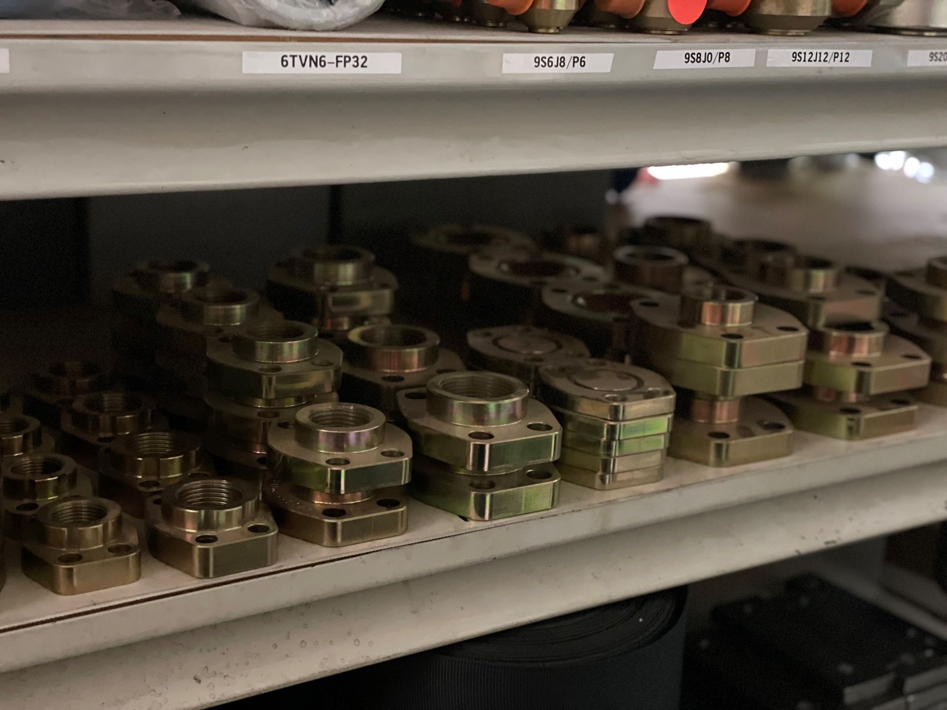 A shelf filled with lots of nuts and bolts