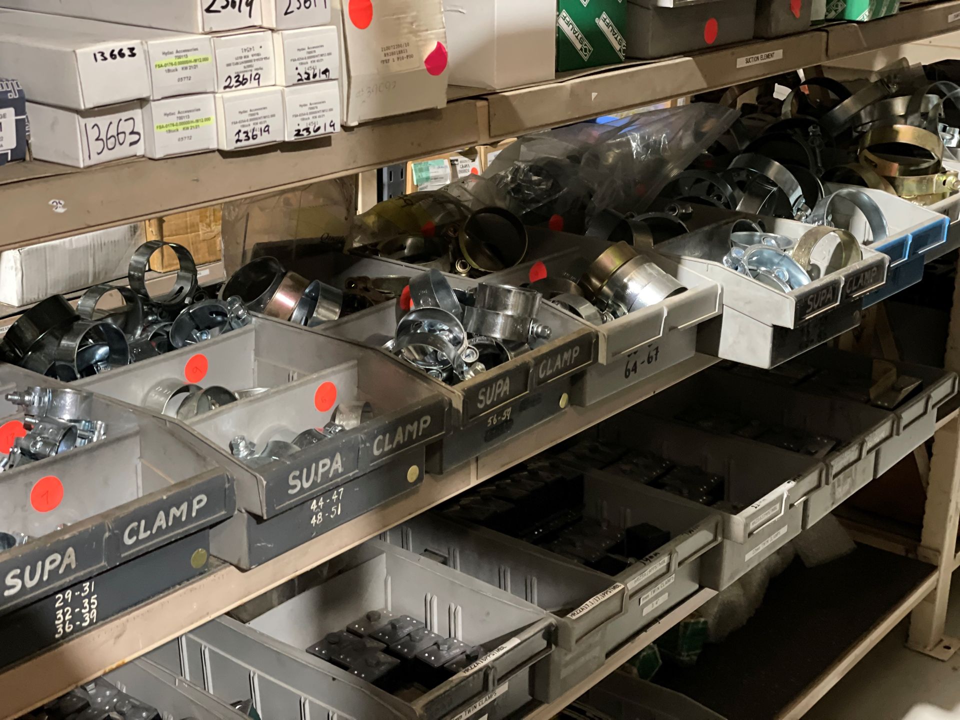 A shelf filled with boxes of clamps and nuts