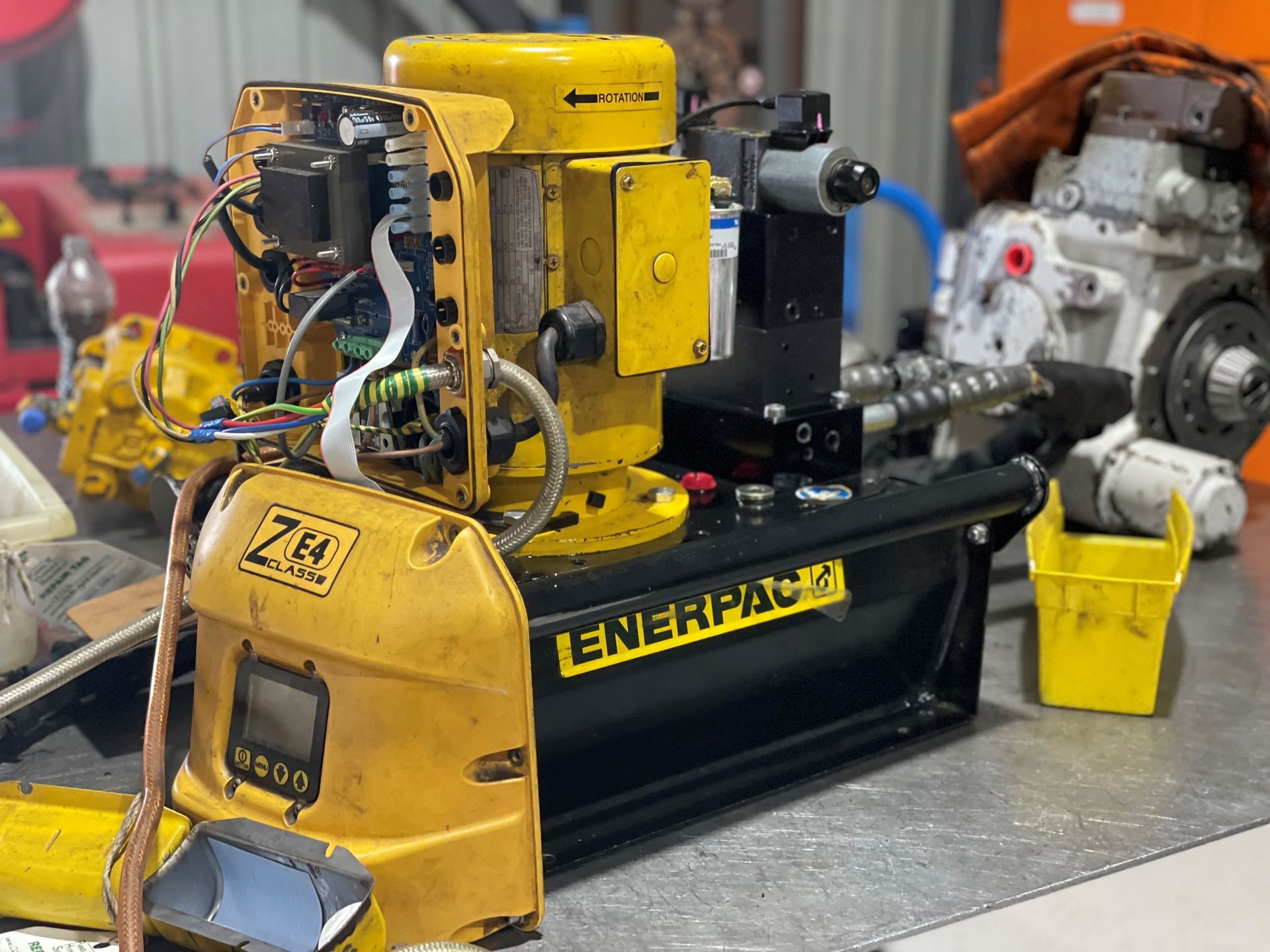 A yellow and black enerpac machine is sitting on a table.