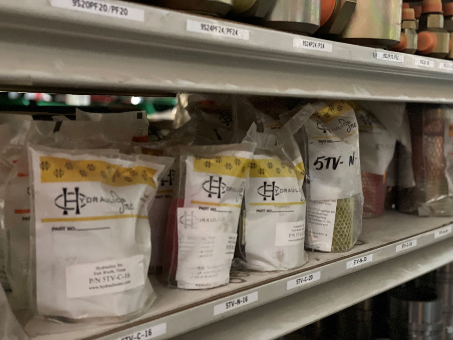 A shelf filled with bags of food including 5tv n
