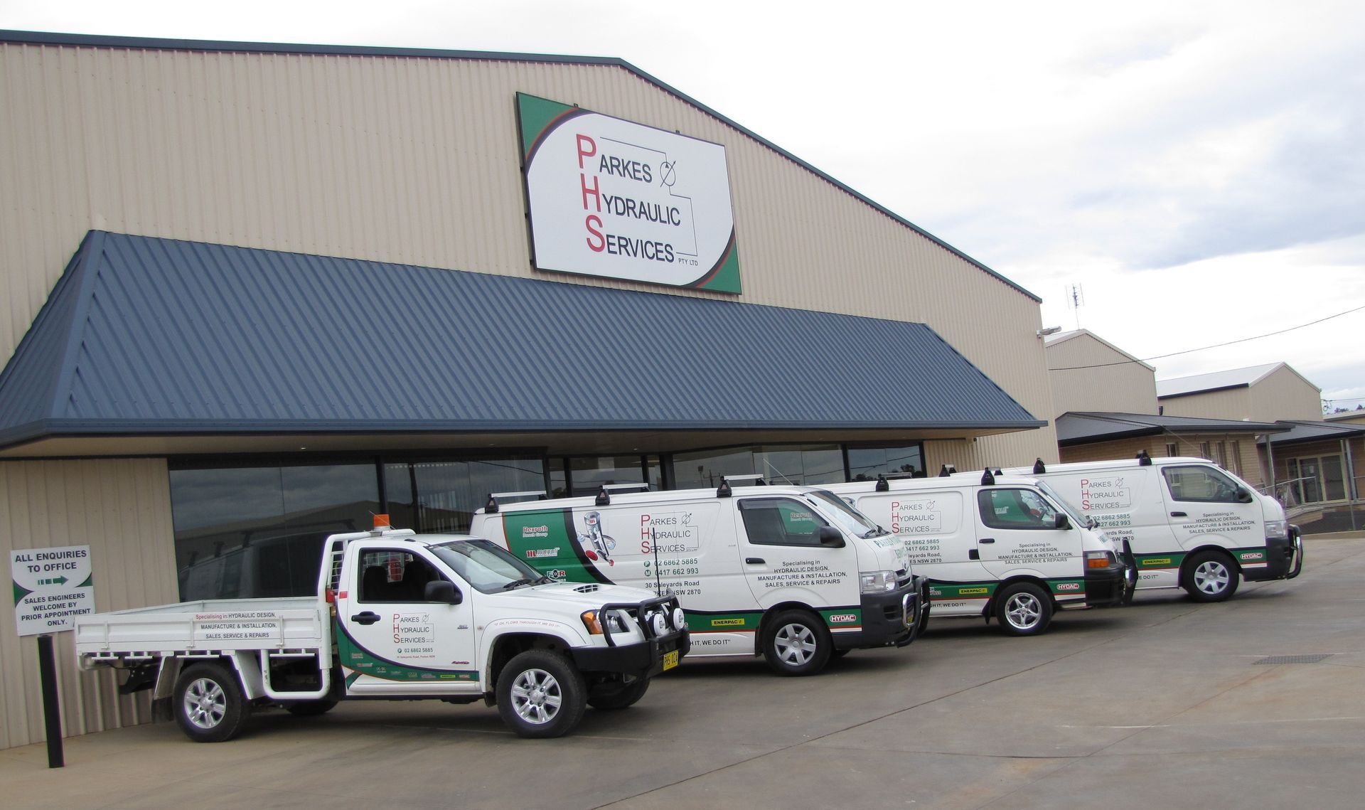 A row of trucks parked in front of a building