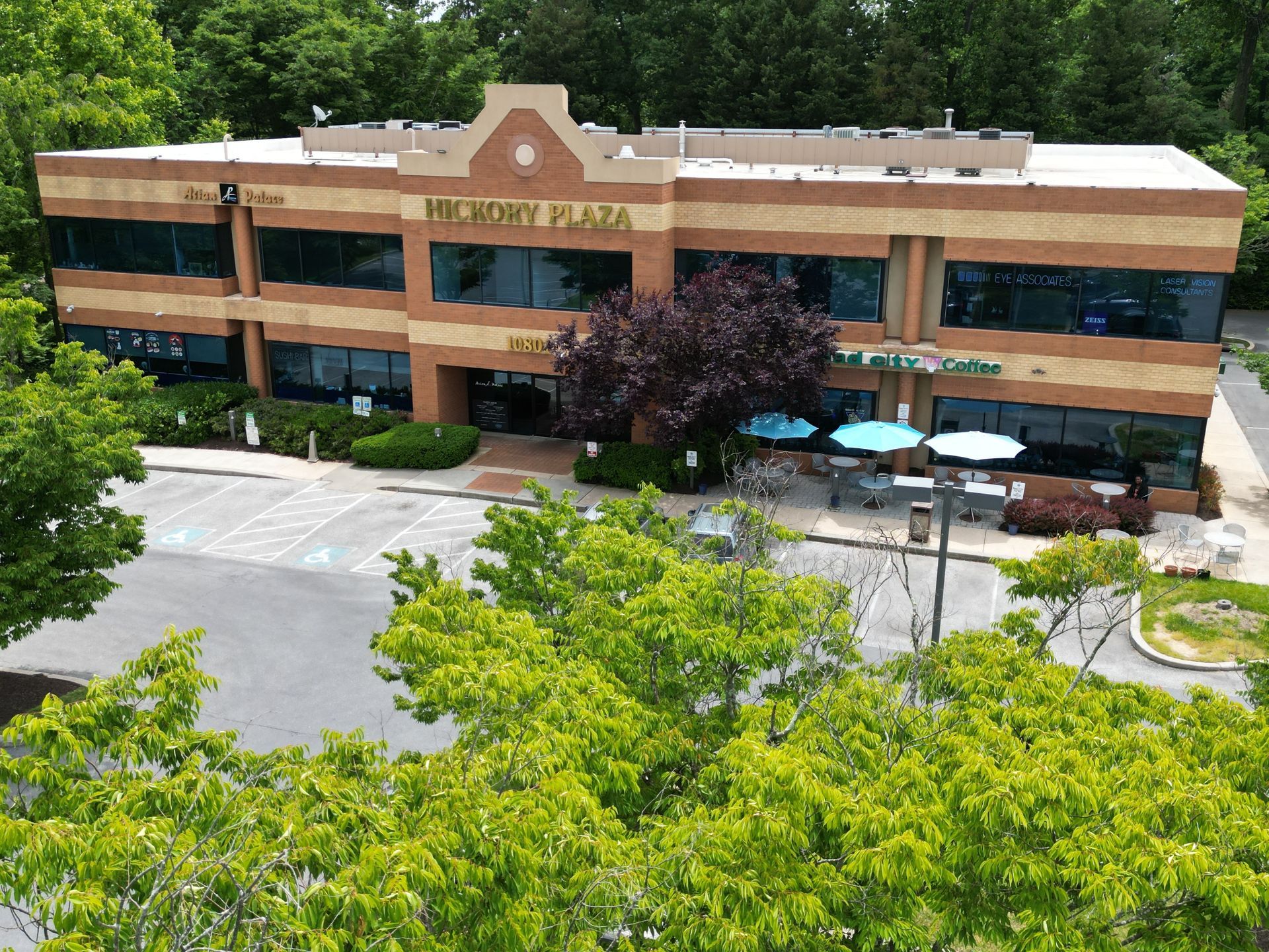 An aerial view of a large office building surrounded by trees