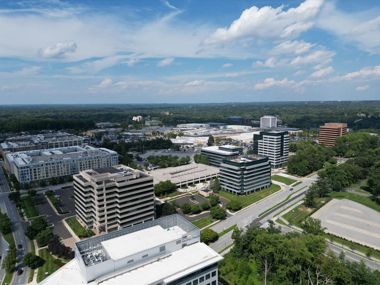 An aerial view of a city with lots of buildings and trees.