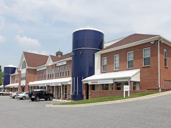 A large brick building with blue silos on the side