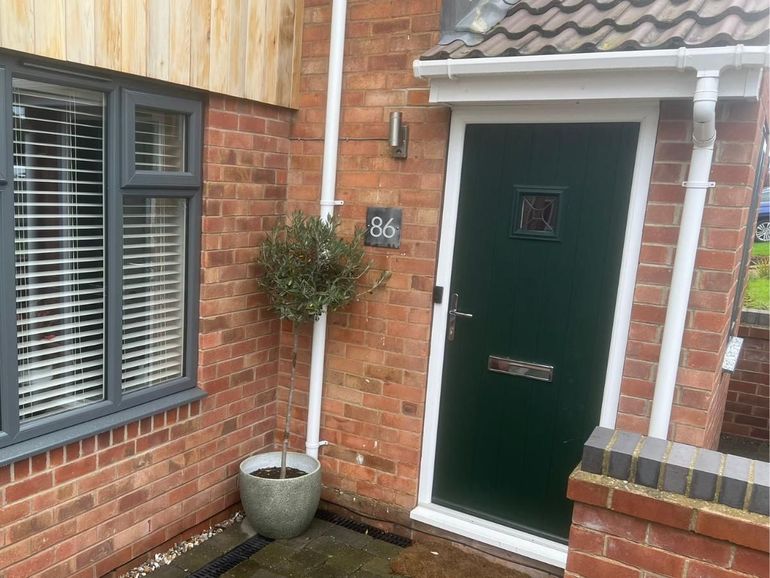 The same Ruddington door after spraying Farrow & Ball Hopper Head green