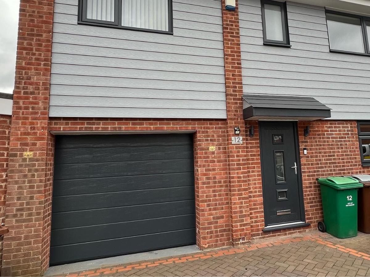 Spray Maestro after finishing a garage door spraying project from white to grey