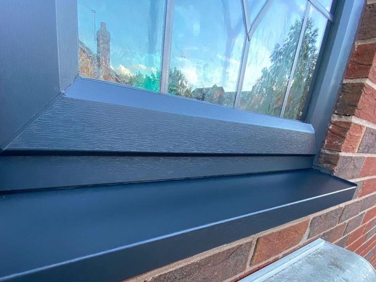 The same window sill and frame after preparation and spraying anthracite grey