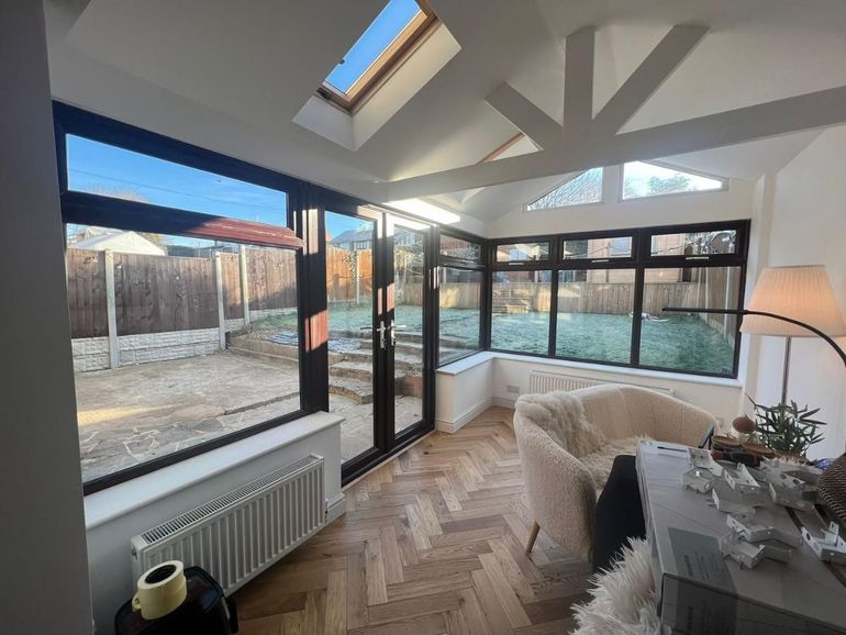 Conservatory interior in Giltbrook with dark brown frames before spraying