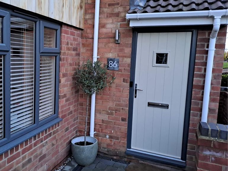 Pale front door on a brick house in Ruddington before spraying