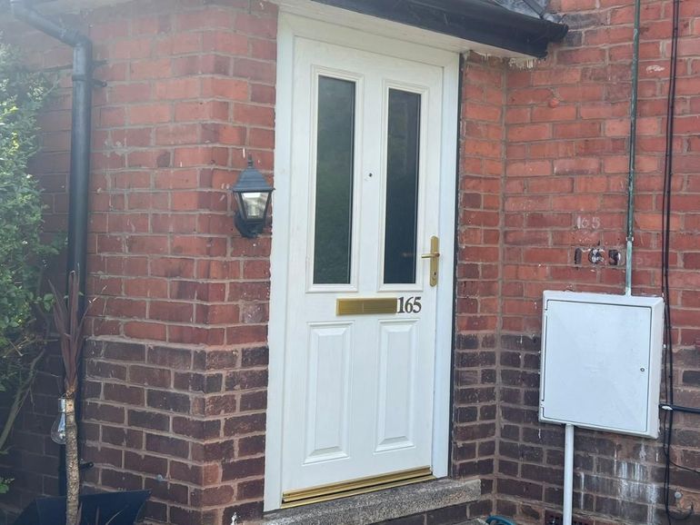 White uPVC front door in a brick porch in West Bridgford before spraying