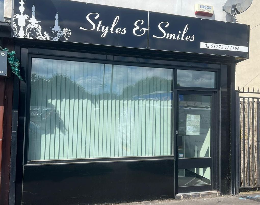 Black shop front with black framing and fascia before respraying