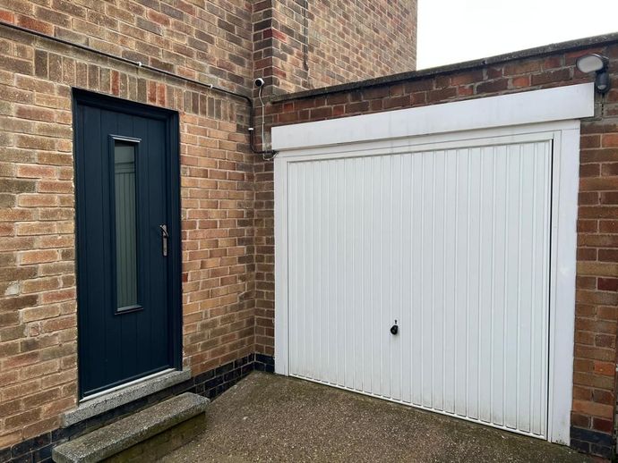 Original white garage door, mismatched with front door