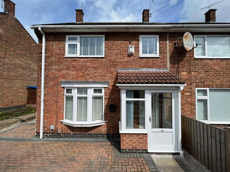 Semi-detached house in Nottingham with white fascias, gutters, downpipe and bay before spraying