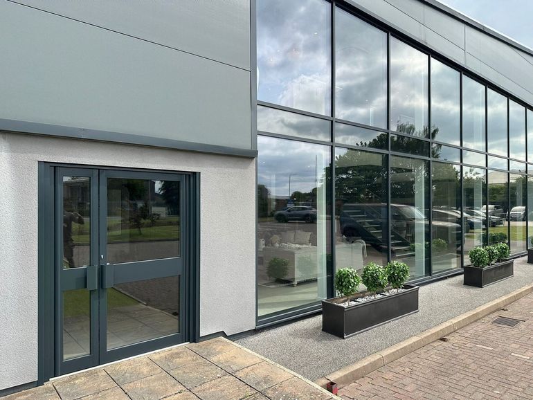 The same entrance doors in Newark after spraying RAL 7016 anthracite grey to match the curtain walling alongside