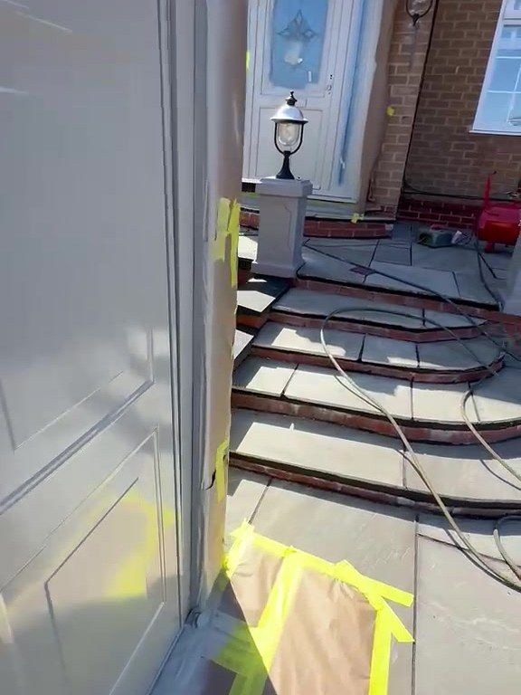 Garage door and uPVC front door of the same house in Ashby-de-la-Zouch during spraying