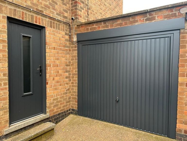 Up-and-over garage door and side door sprayed anthracite grey